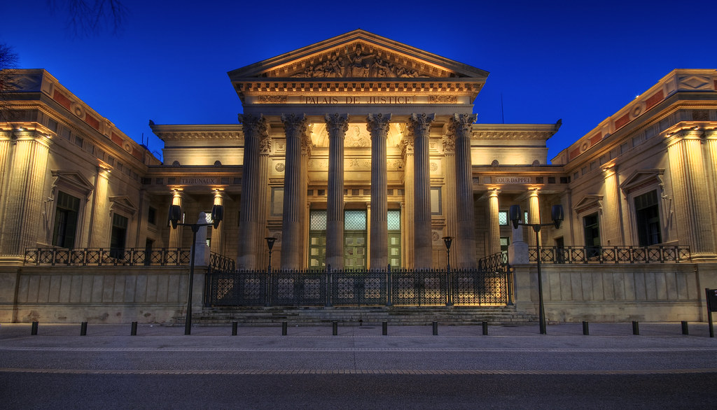 Illuminated neoclassical building with columns at night.