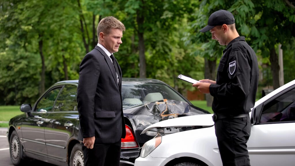 Police officer and man at car accident.