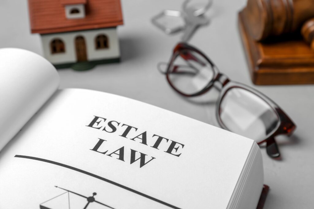 Estate law book with glasses and gavel.