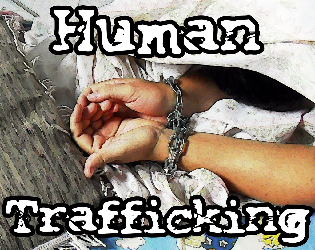 Hands in chains, human trafficking text overlay.